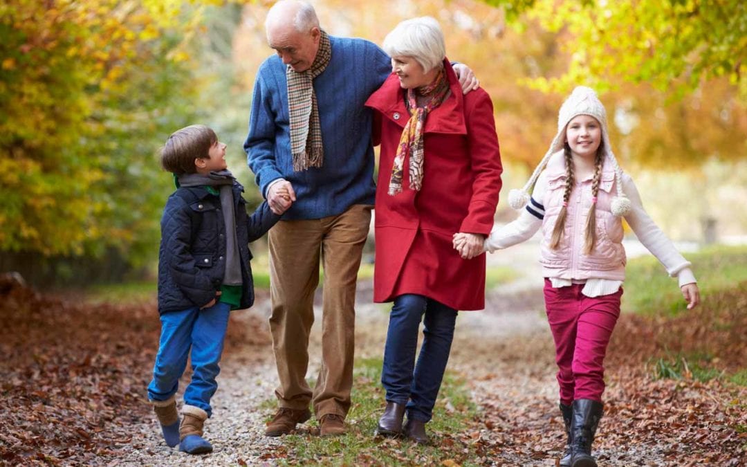 Nagyszülők unokákkal természetben sétálnak egészséges életmód és csontozat